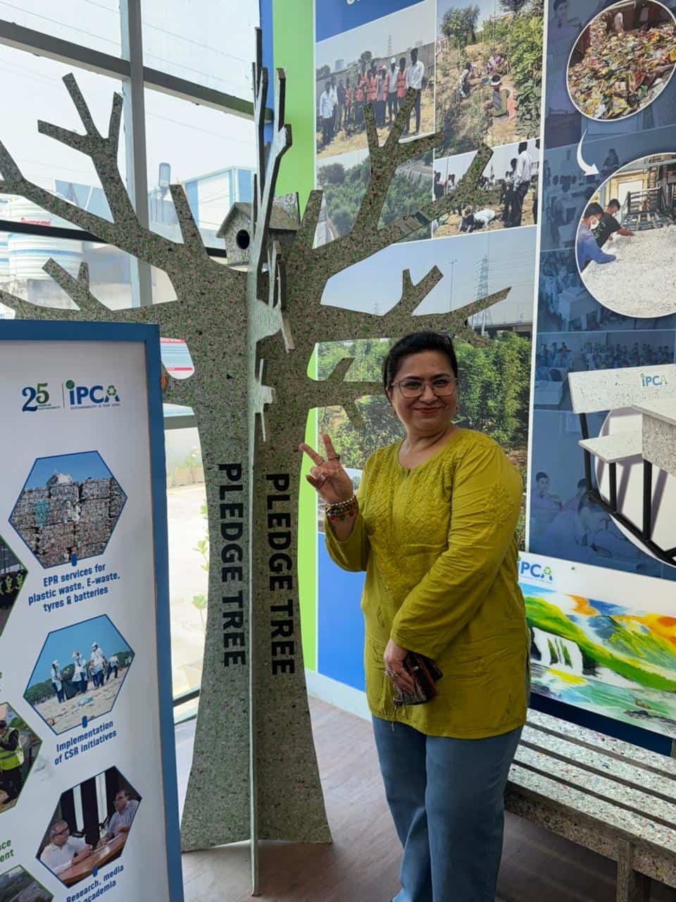 Volunteer beside an environmental awareness display