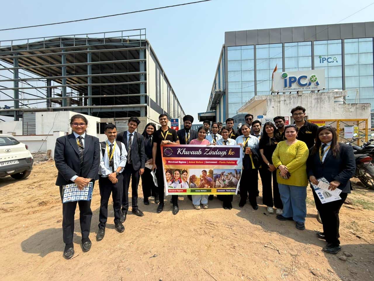 Student volunteers holding an awareness banner outside